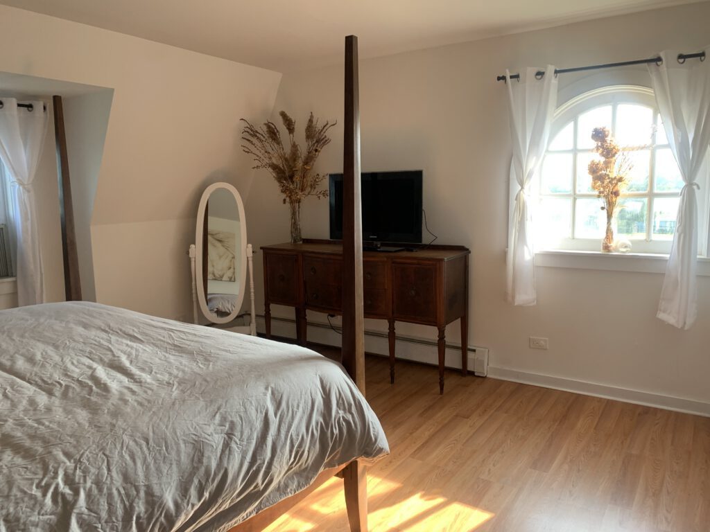 Calm bedroom with hardwood floors and soft window light